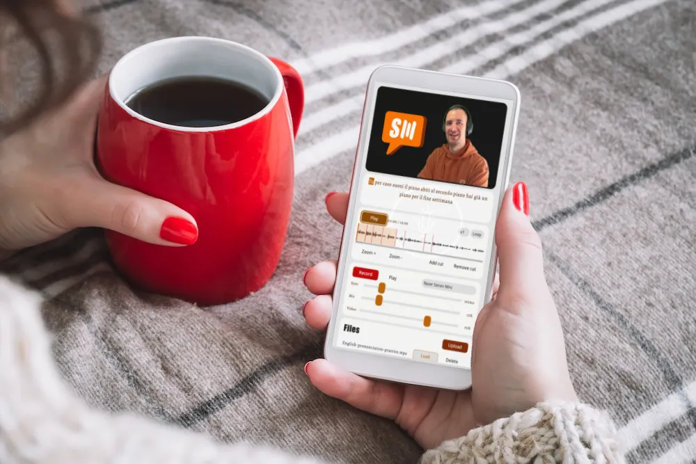 Person using language learning app on smartphone with coffee in morning routine